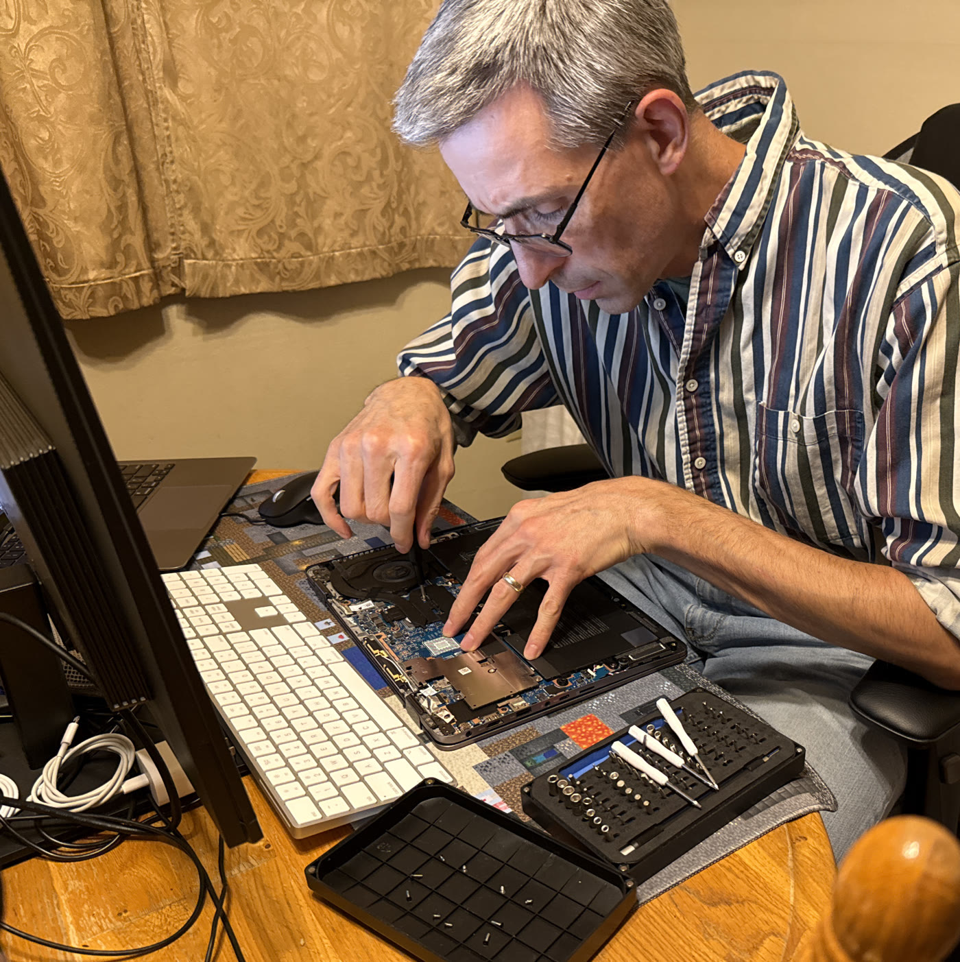 David Shaver repairing a laptop